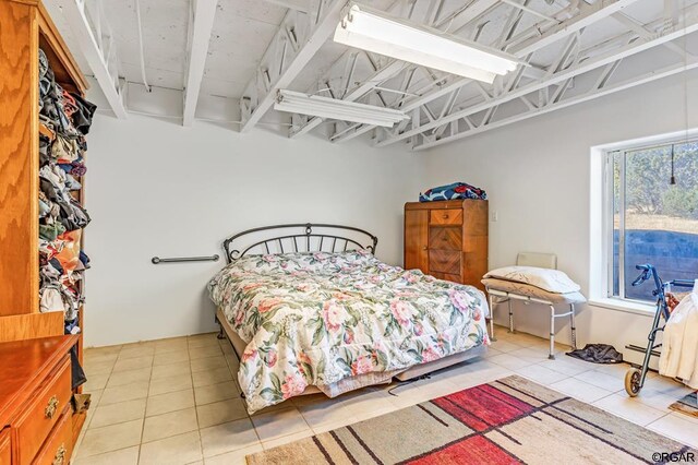 bedroom with light tile patterned floors