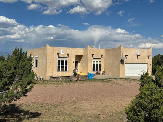 rear view of property featuring a garage