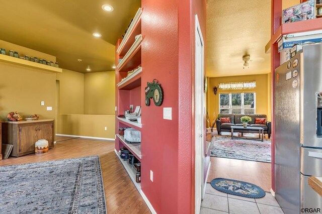 hallway with light hardwood / wood-style floors