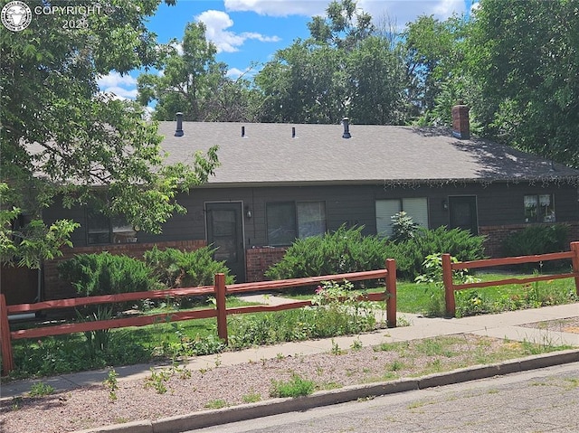 910 Allison Ave Unit A & B, Canon City, CO 81212 - view of front of property with brick siding, a chimney, and roof with shingles
