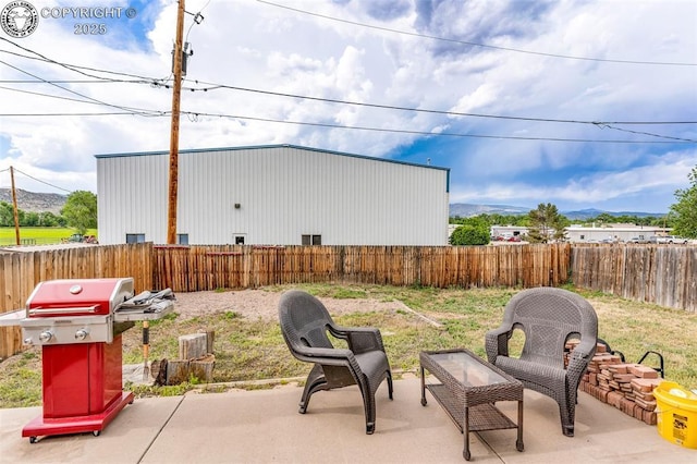 723 Griffin Ave, Canon City, CO 81212 - fenced backyard with area for grilling, a mountain view, and a patio area