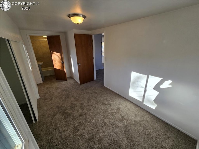 unfurnished bedroom with dark carpet