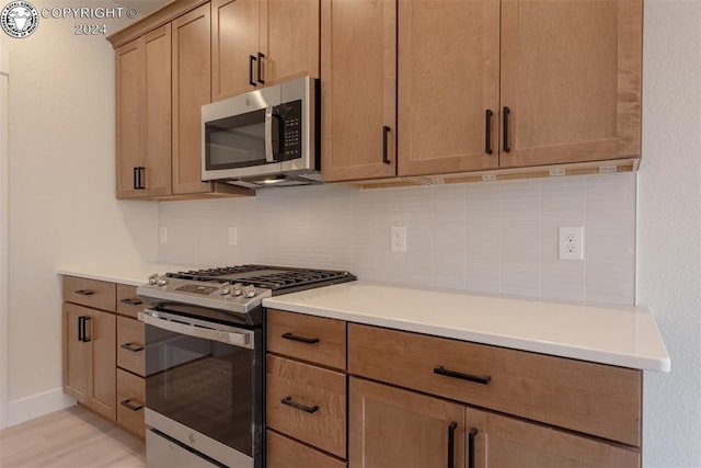 kitchen with backsplash and stainless steel appliances