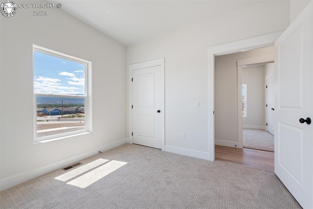 unfurnished bedroom with light colored carpet