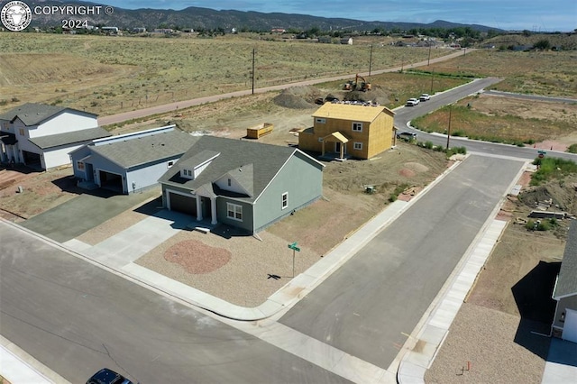 birds eye view of property featuring a mountain view