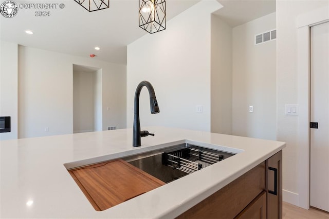 kitchen featuring pendant lighting and sink