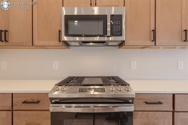 kitchen with decorative backsplash and appliances with stainless steel finishes