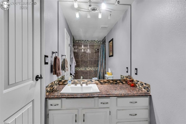 bathroom featuring tasteful backsplash, vanity, and a shower with shower curtain