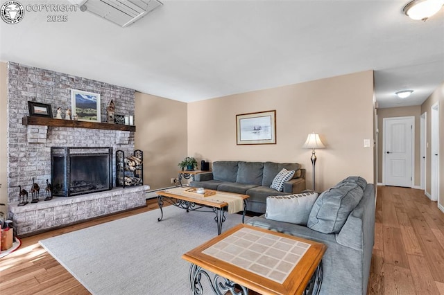 living room featuring a fireplace and light hardwood / wood-style floors