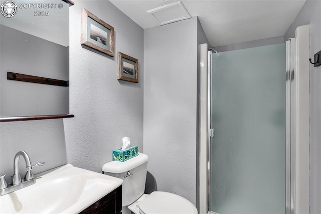 bathroom featuring vanity, an enclosed shower, and toilet