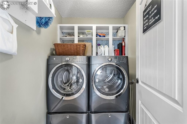 clothes washing area featuring washer and dryer and a textured ceiling