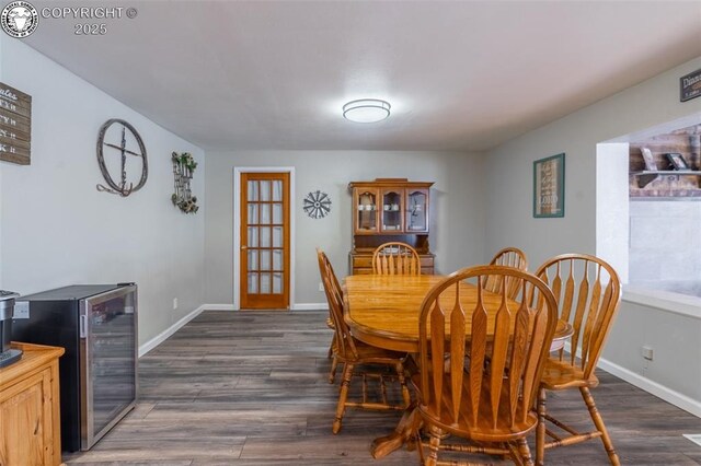 dining area with wine cooler and dark hardwood / wood-style floors