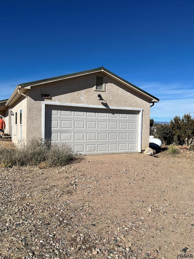 view of side of property featuring a garage