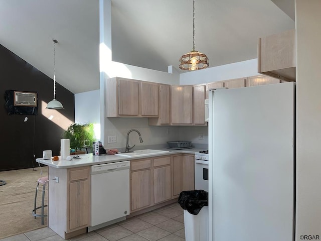 kitchen featuring light brown cabinetry, sink, refrigerator, hanging light fixtures, and white dishwasher