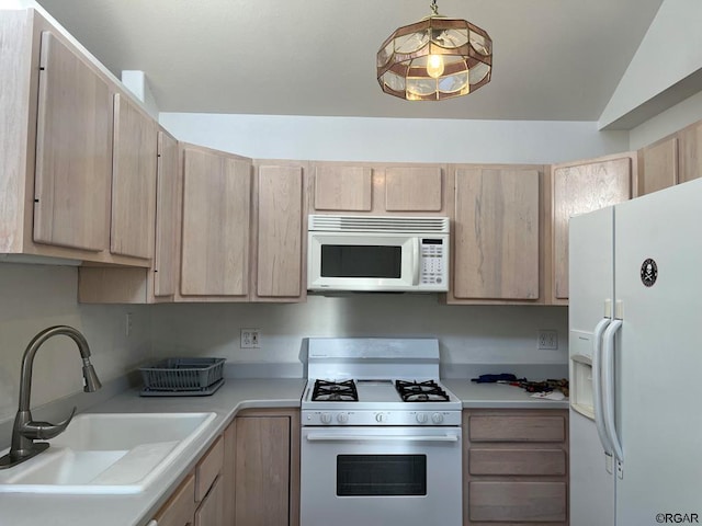 kitchen with lofted ceiling, sink, light brown cabinets, pendant lighting, and white appliances