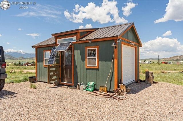 view of outdoor structure featuring a garage and a mountain view