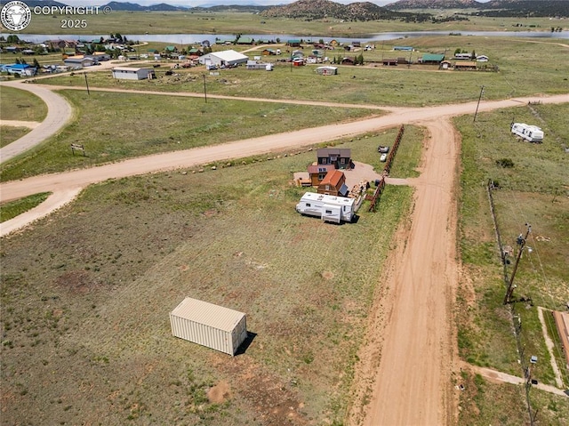 drone / aerial view featuring a water view and a rural view