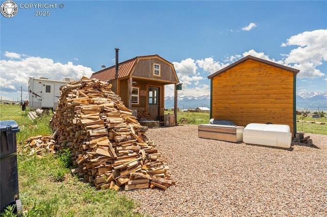 exterior space with a mountain view and an outbuilding