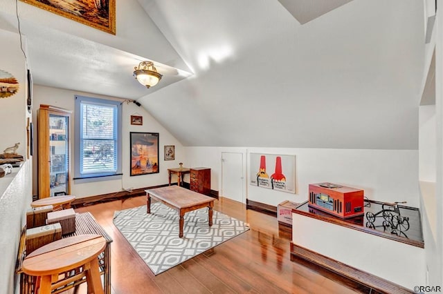 game room featuring lofted ceiling and light wood-type flooring