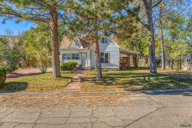 view of front facade with a carport and a front yard