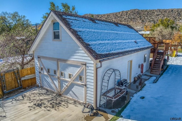 exterior space with a garage and an outbuilding