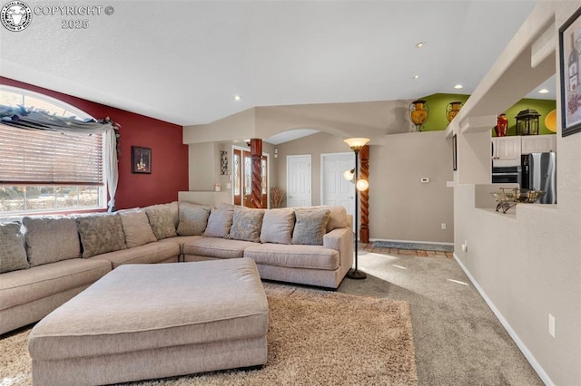 carpeted living room featuring lofted ceiling