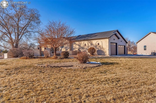 view of front of home with a garage and a front yard