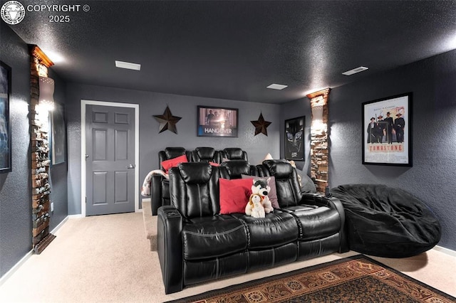 home theater with light colored carpet and a textured ceiling