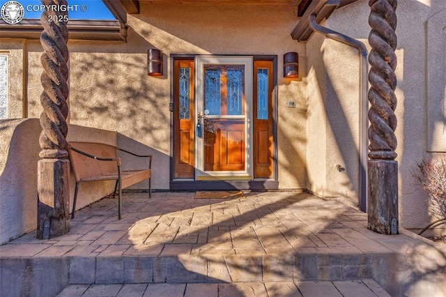 entrance to property featuring a patio area