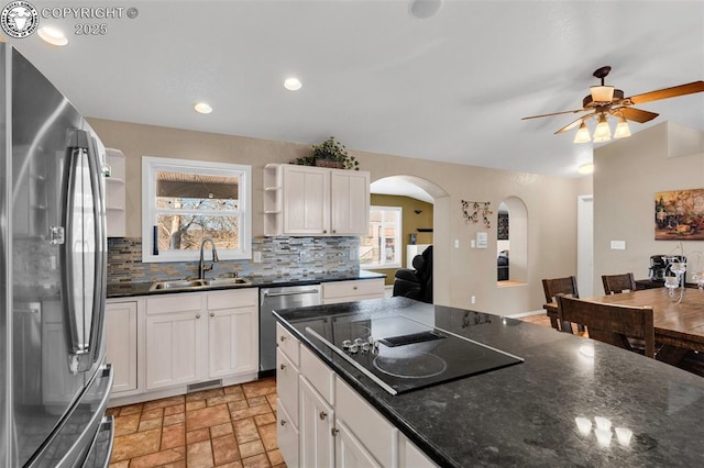 kitchen with white cabinetry, appliances with stainless steel finishes, sink, and tasteful backsplash