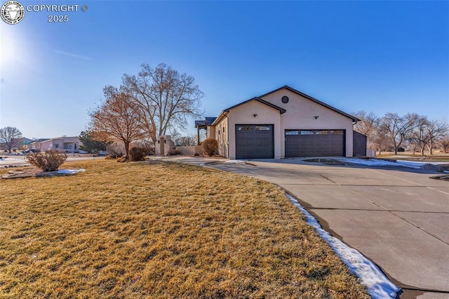 view of property exterior with a garage and a yard