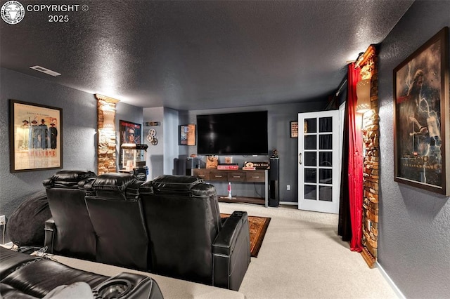 carpeted cinema room featuring a textured ceiling