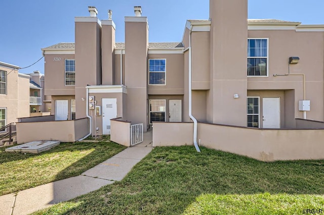 rear view of property featuring a yard