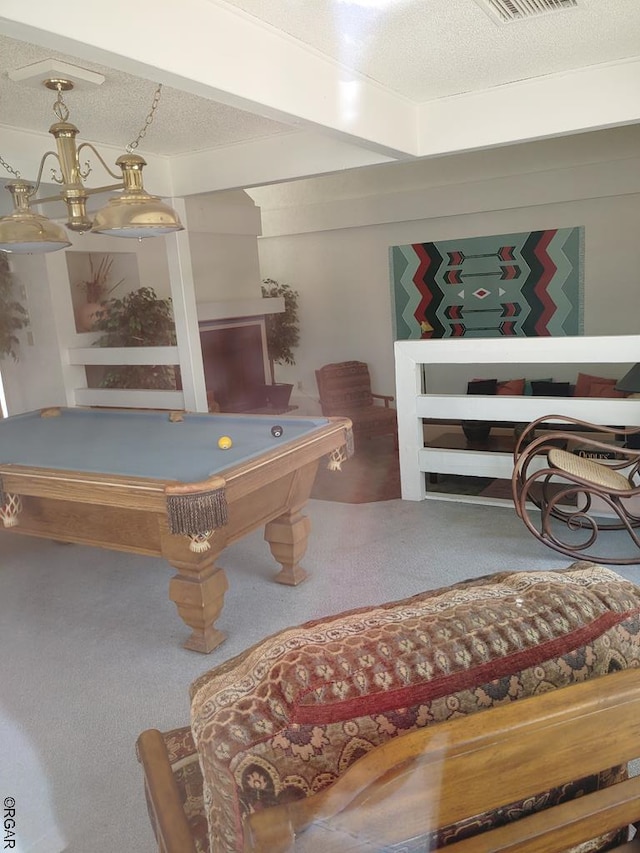 playroom with pool table, carpet, and a textured ceiling