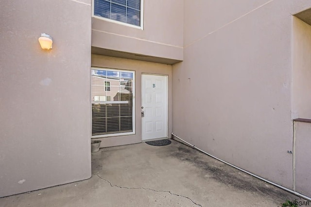 view of exterior entry featuring a patio