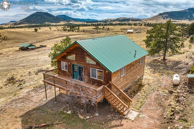 180 E Cobb Ln, Guffey, CO 80820 - exterior space featuring stairs, a rural view, and a deck with mountain view