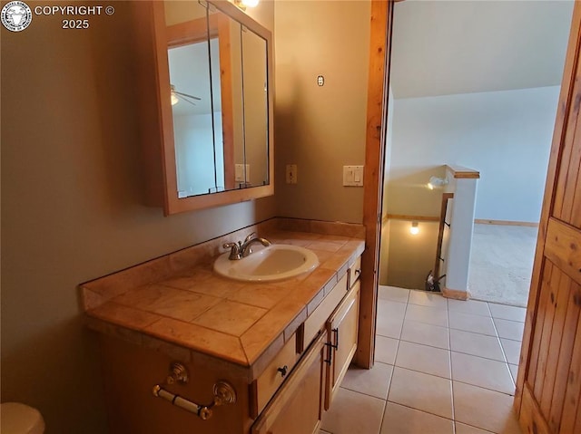 bathroom with tile patterned flooring, vanity, and baseboards