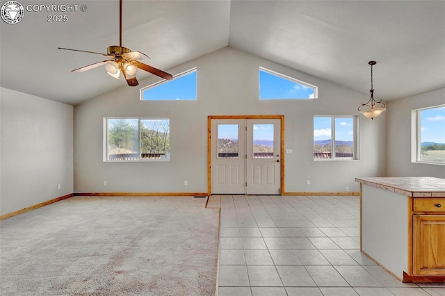 180 E Cobb Ln, Guffey, CO 80820 - foyer entrance featuring baseboards, light tile patterned flooring, ceiling fan, and high vaulted ceiling