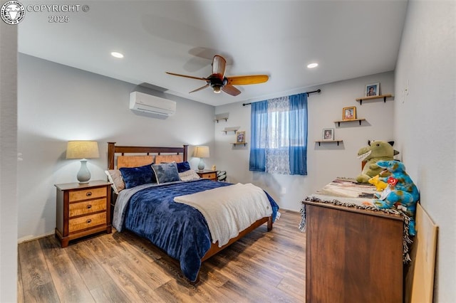 bedroom with dark hardwood / wood-style floors, a wall mounted air conditioner, and ceiling fan