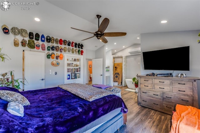 bedroom featuring lofted ceiling, ensuite bath, ceiling fan, a wall mounted air conditioner, and dark hardwood / wood-style flooring