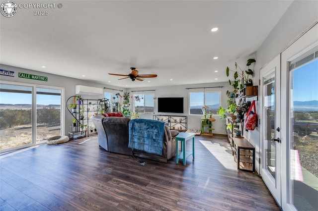 living room featuring an AC wall unit, dark hardwood / wood-style floors, and ceiling fan