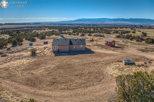 birds eye view of property with a mountain view