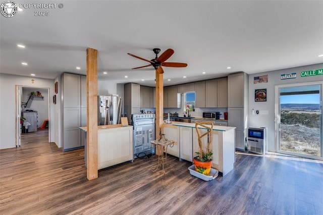 kitchen with dark hardwood / wood-style flooring, gray cabinets, ceiling fan, and appliances with stainless steel finishes