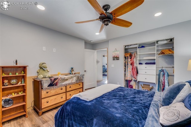 bedroom with a closet, ceiling fan, and light hardwood / wood-style flooring