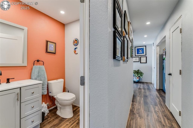 corridor with dark hardwood / wood-style floors and sink