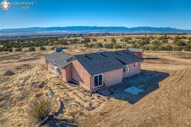 birds eye view of property featuring a mountain view