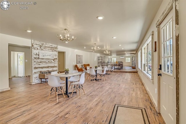 dining area featuring recessed lighting, plenty of natural light, an inviting chandelier, and light wood finished floors