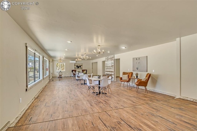 interior space with baseboards, wood finished floors, and a chandelier