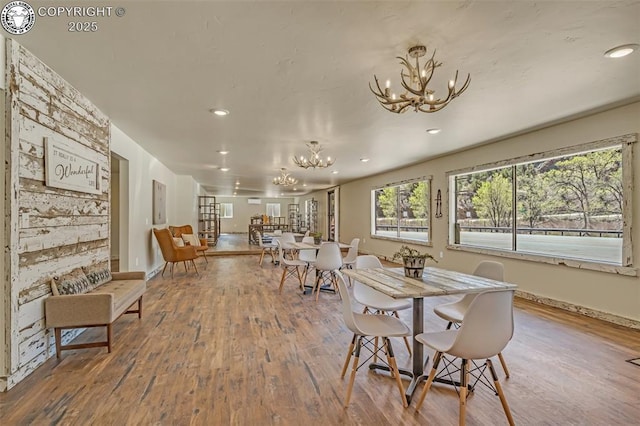 dining room featuring recessed lighting, baseboards, wood finished floors, and a chandelier