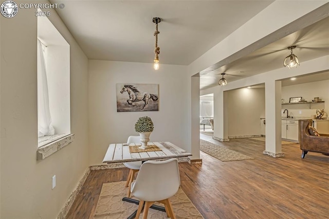 dining room featuring baseboards and wood finished floors